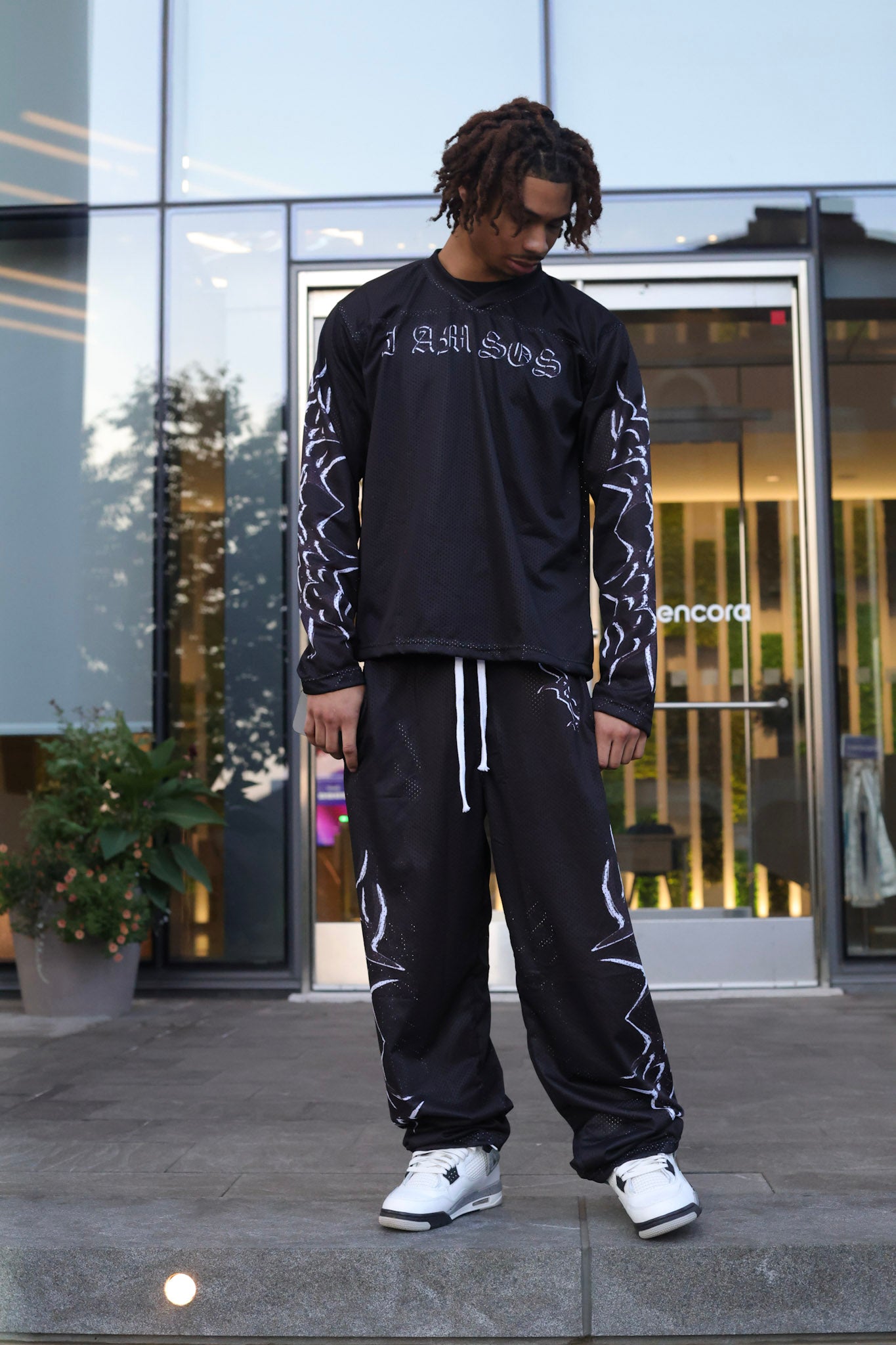 Black "I AM SOS" Mesh Pants