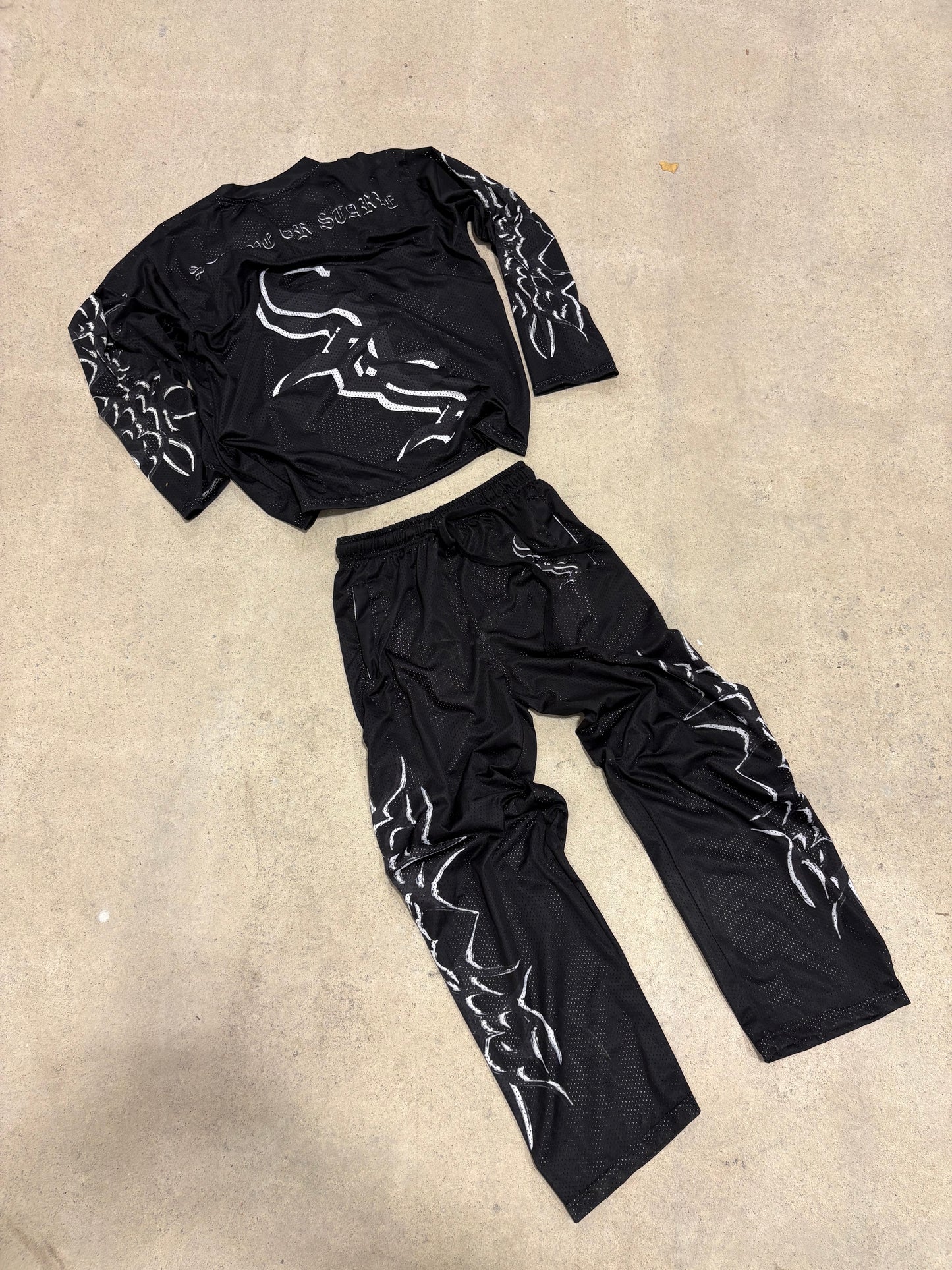 Black "I AM SOS" Mesh Pants
