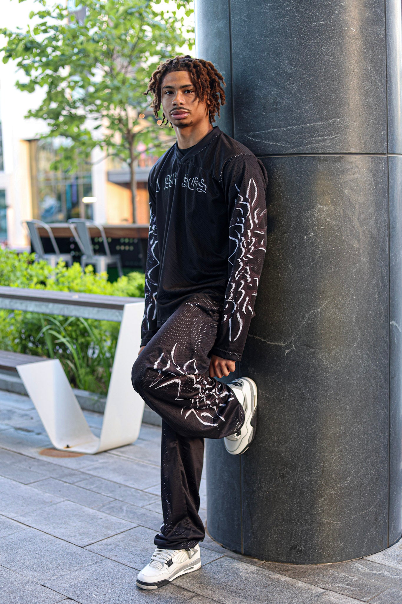 Black "I AM SOS" Mesh Pants