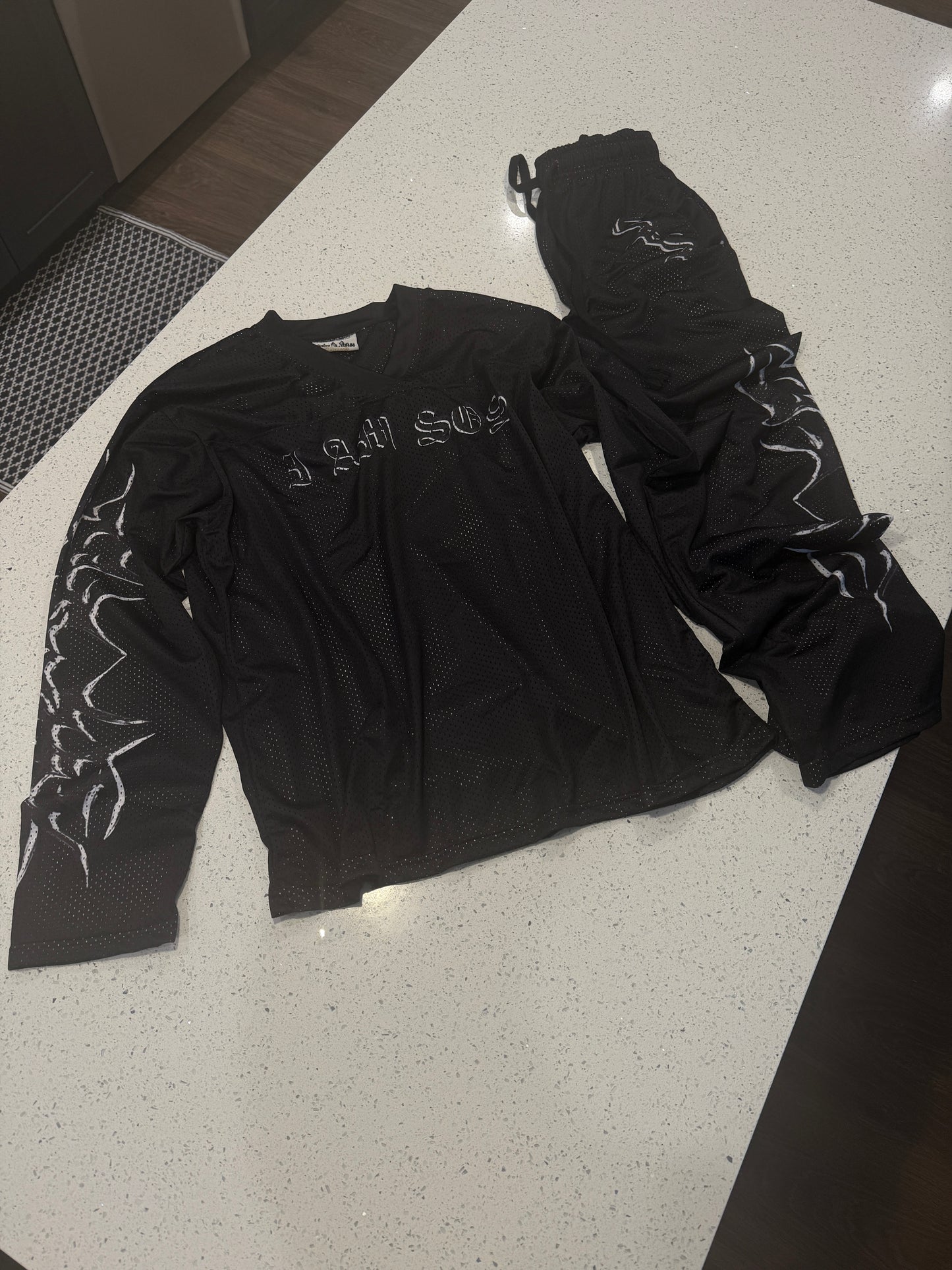 Black "I AM SOS" Mesh Pants